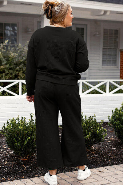 Back View of Women's Black Textured Long Sleeve Top and Drawstring Wide Leg Pants Set