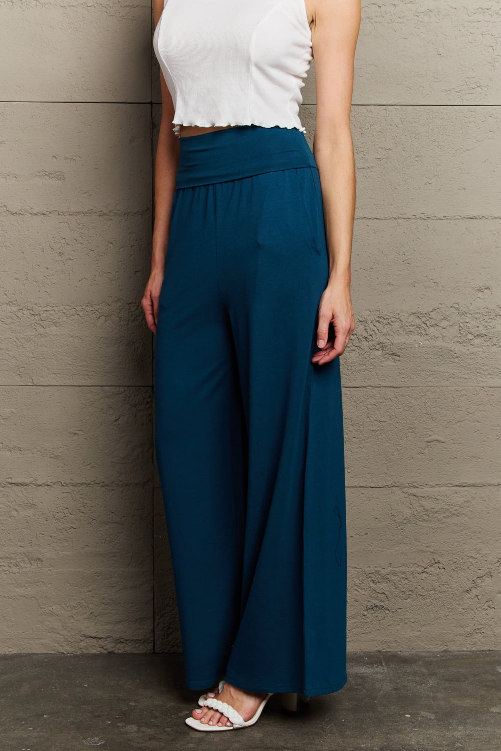 Deep teal palazzo pants with side pockets, side view