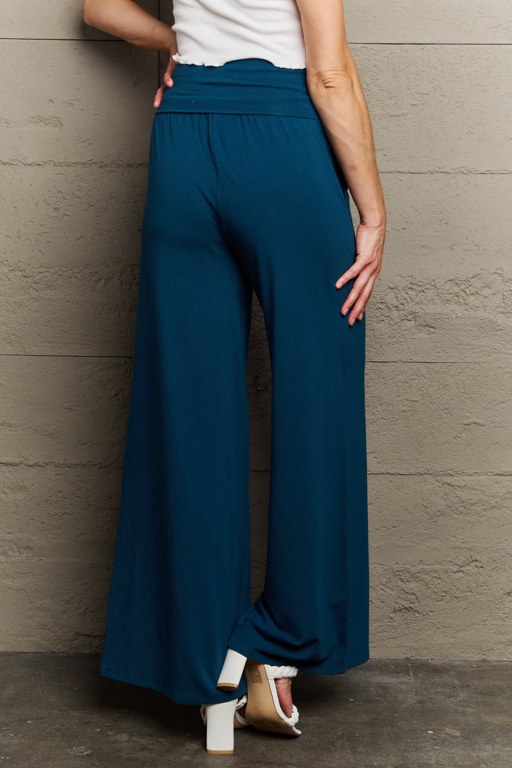 Deep teal palazzo pants with side pockets, back view