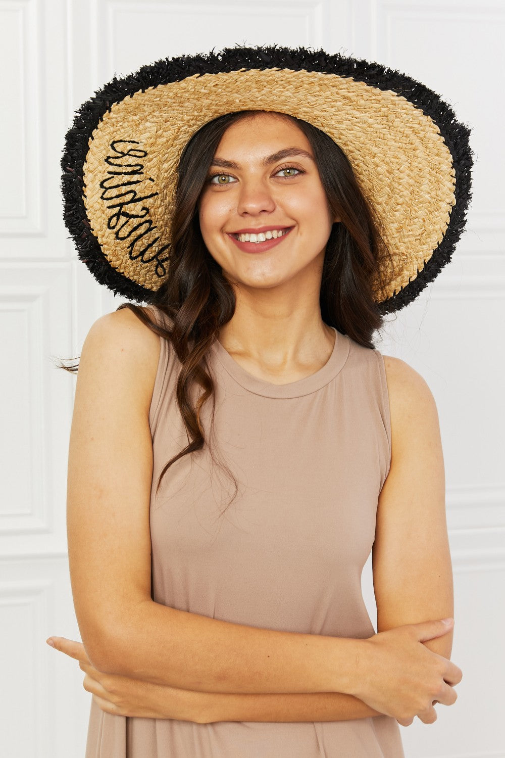 Straw hat with black fringe with sunshine written in black cursive print